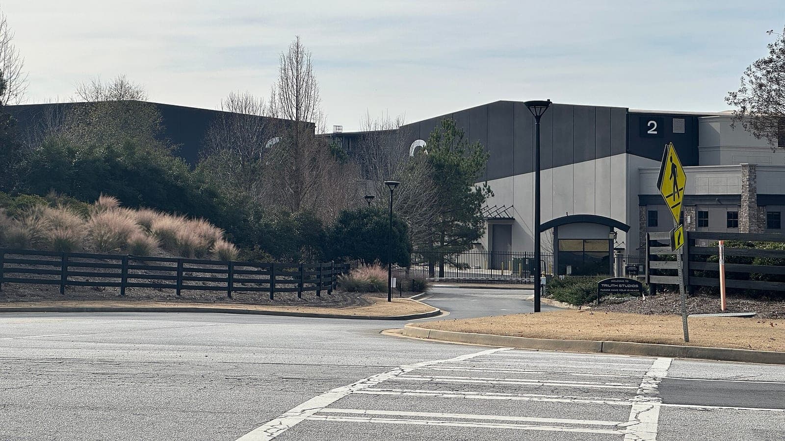 Sound stages at Trilith Studios in Fayetteville, Georgia, seen across an empty road from the gated entrance.