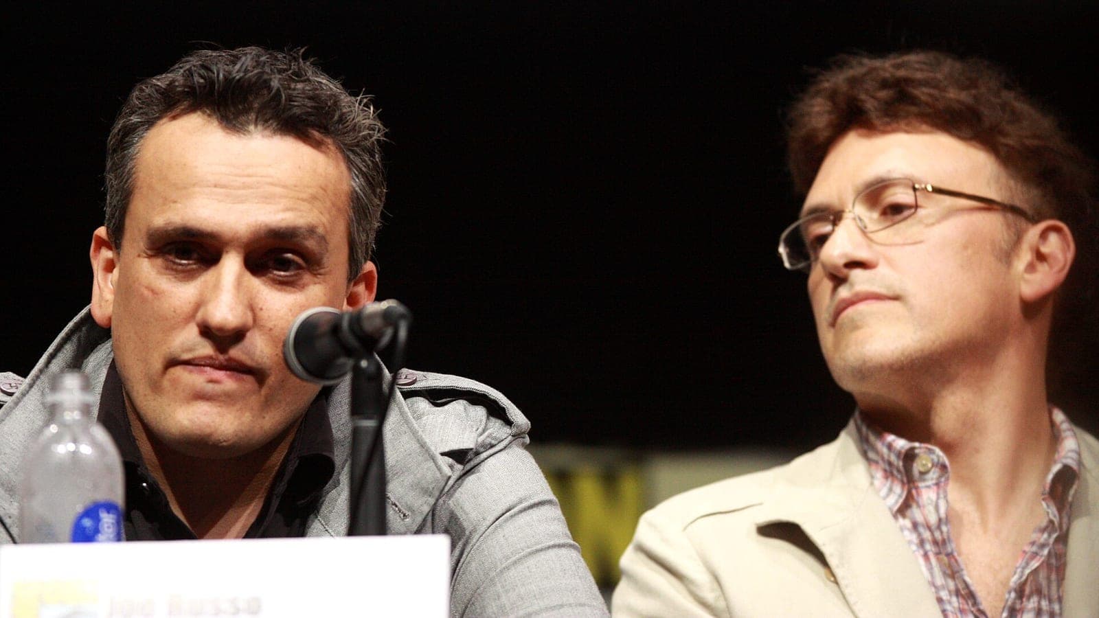 Joe Russo and Anthony Russo, the directors of Avengers: Endgame, seated at microphones during a panel discussion.