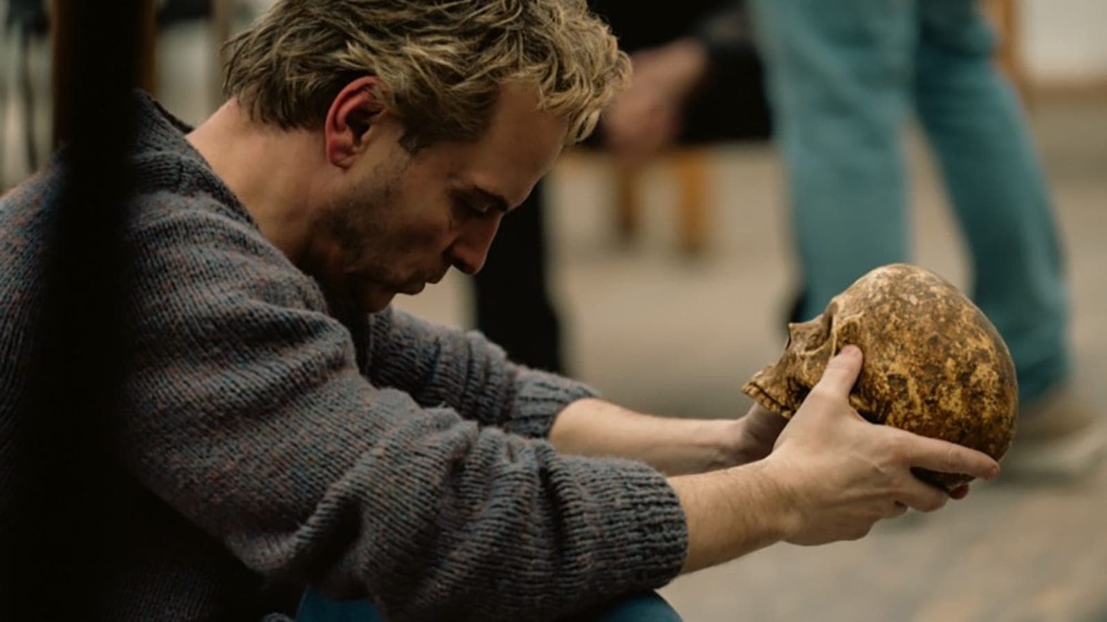 Andrew Scott as Ian Charleson sits on a rehearsal-room floor holding a skull in a still from Elsinore