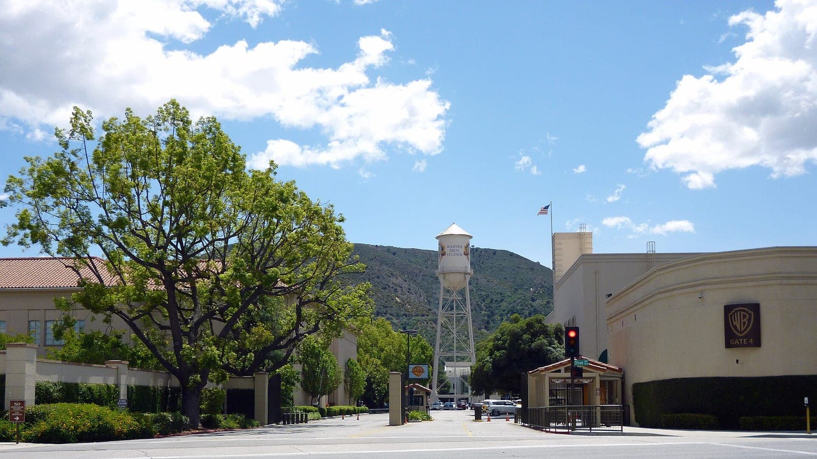 The Gate 4 entrance to the Warner Bros. Studios lot in Burbank, with the studio water tower behind it.