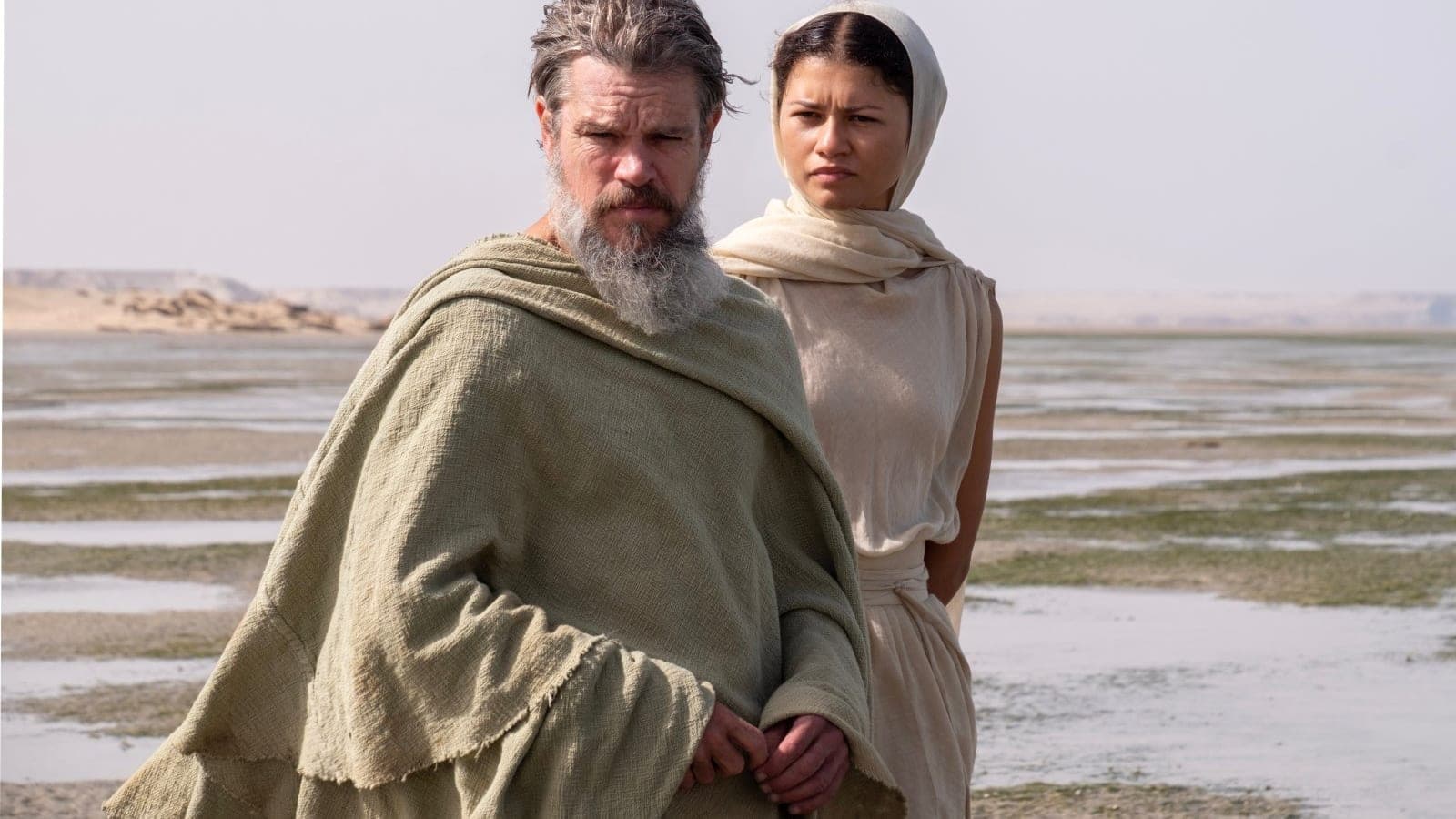 L to R: Matt Damon is Odysseus and Zendaya is Athena in THE ODYSSEY, written, produced, and directed by Christopher Nolan.